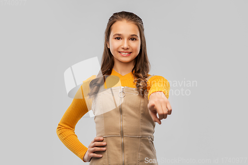 Image of smiling young teenage girl pointing to camera