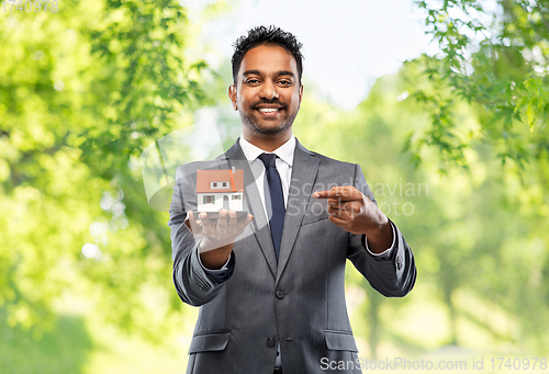 Image of indian man realtor with house model