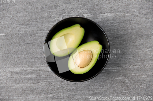 Image of close up of ripe avocado with bone in ceramic bowl