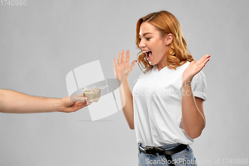 Image of happy couple in white t-shirts with christmas gift