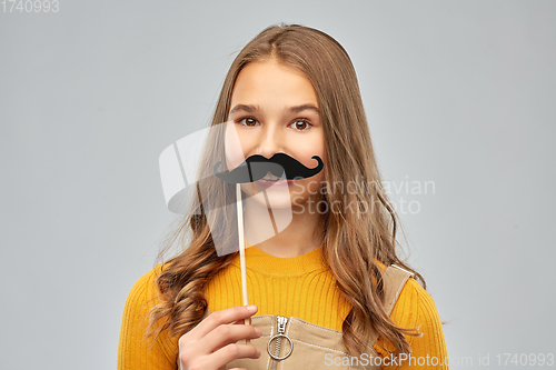 Image of teenage girl with black moustaches party accessory