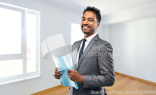 Image of indian man realtor with folder at new apartment