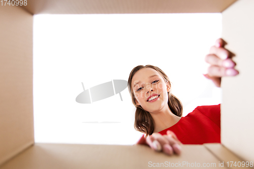 Image of happy young woman looking into open gift box