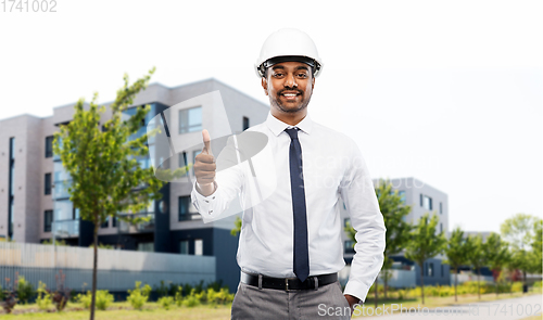 Image of architect showing thumbs up on city street