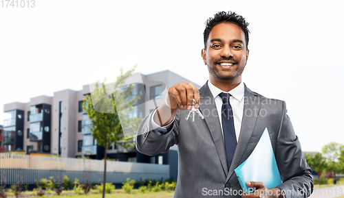 Image of indian man realtor with home keys on city street