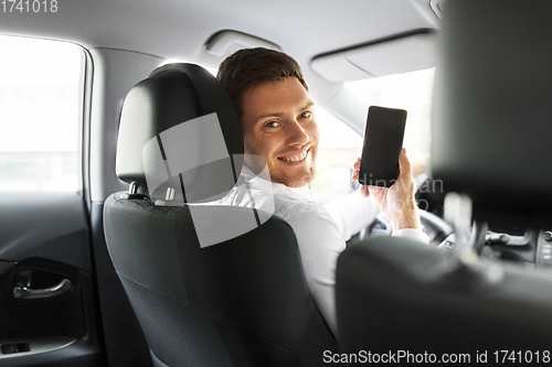 Image of man or car driver showing smartphone