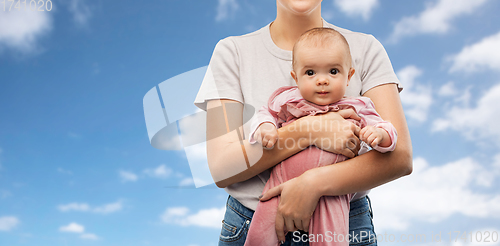 Image of happy young mother holding little baby daughter