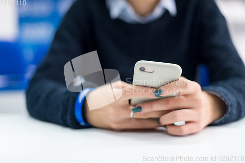 Image of female student using a mobile phone