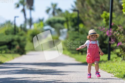 Image of little girl runing in the summer Park