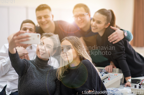 Image of young happy students doing selfie picture