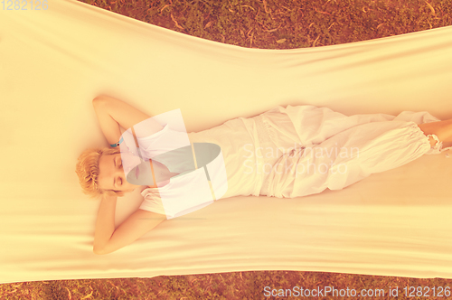 Image of young woman resting on hammock
