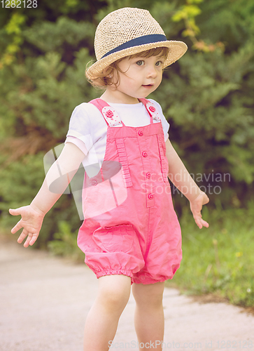 Image of little girl runing in the summer Park