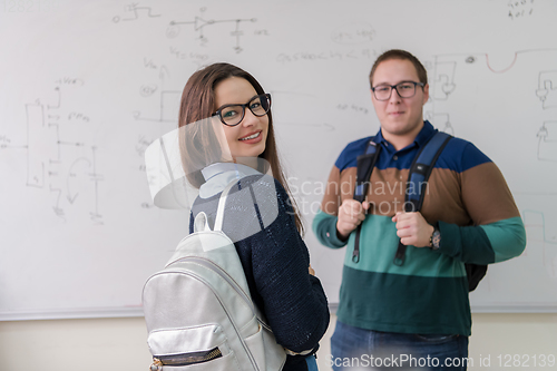 Image of portrait of young students in front of chalkboard