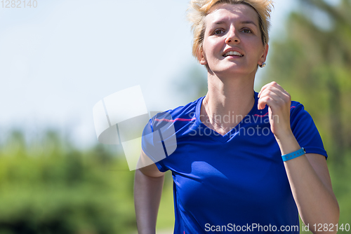 Image of young female runner training for marathon