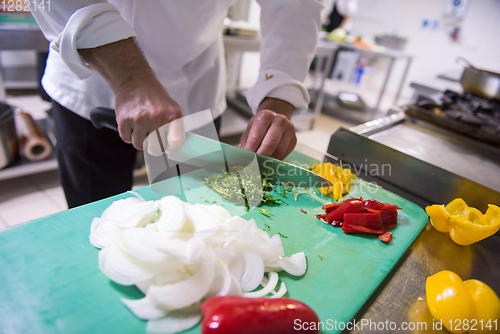 Image of Chef hands cutting fresh and delicious vegetables