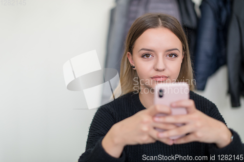 Image of female student using a mobile phone