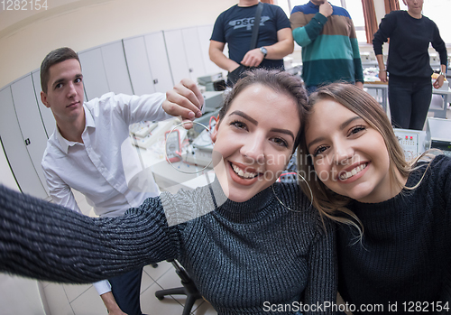 Image of young happy students doing selfie picture