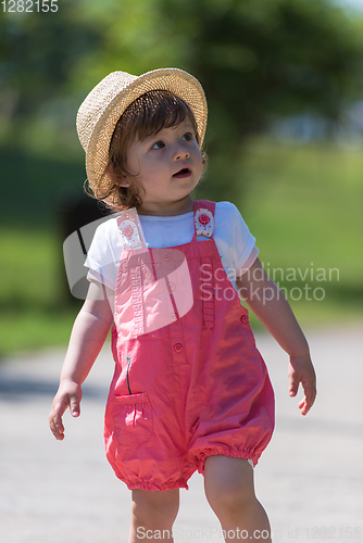 Image of little girl runing in the summer Park