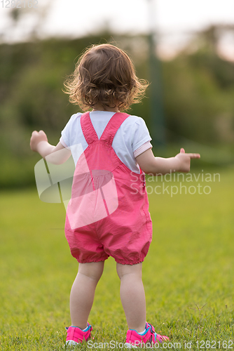 Image of little girl spending time at backyard