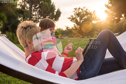 Image of mom and a little daughter relaxing in a hammock