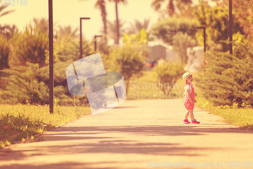 Image of little girl runing in the summer Park