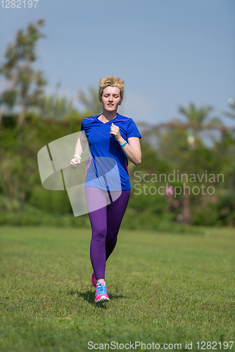 Image of young female runner training for marathon