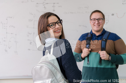 Image of portrait of young students in front of chalkboard