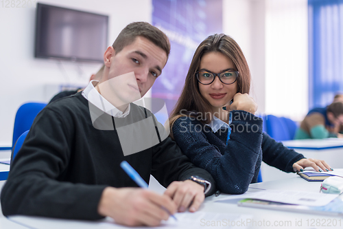 Image of young students writing notes