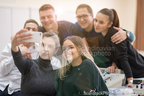 Image of young happy students doing selfie picture