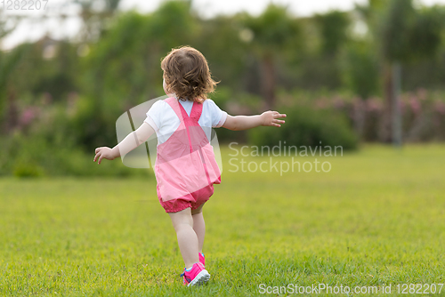 Image of little girl spending time at backyard