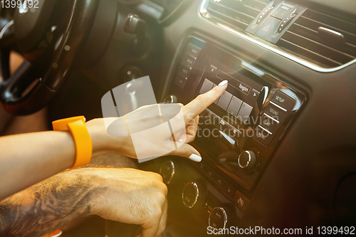 Image of Young couple preparing for vacation trip on the car in sunny day