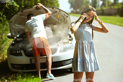 Image of Young couple traveling on the car in sunny day