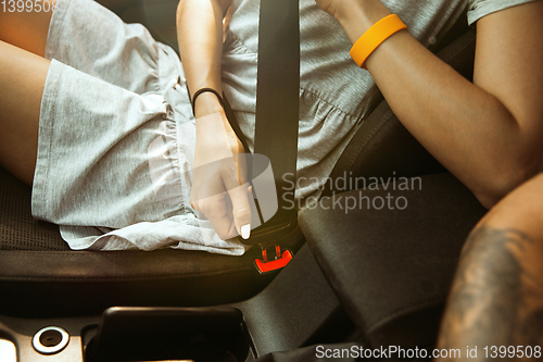 Image of Young couple preparing for vacation trip on the car in sunny day