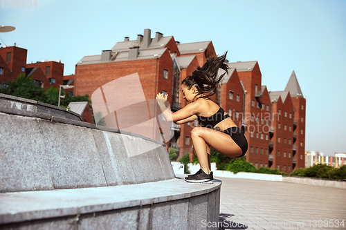 Image of A muscular athletes doing workout on the city\'s street or park