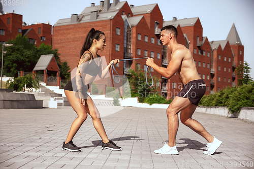 Image of A muscular athletes doing workout on the city\'s street or park