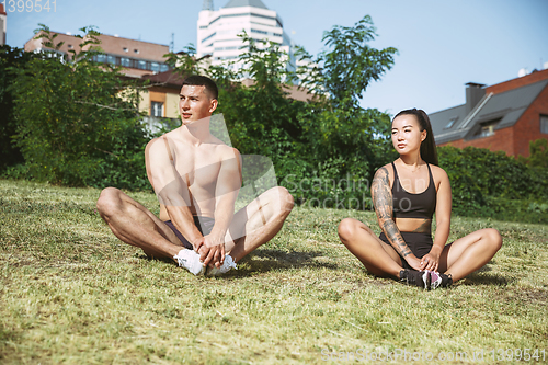Image of A muscular athletes doing workout on the city\'s street or park