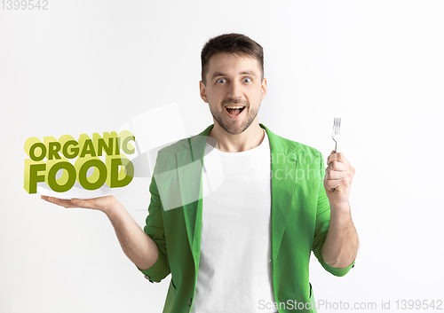 Image of Food concept. Model holding a plate with letters of Organic food