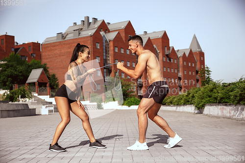 Image of A muscular athletes doing workout on the city\'s street or park