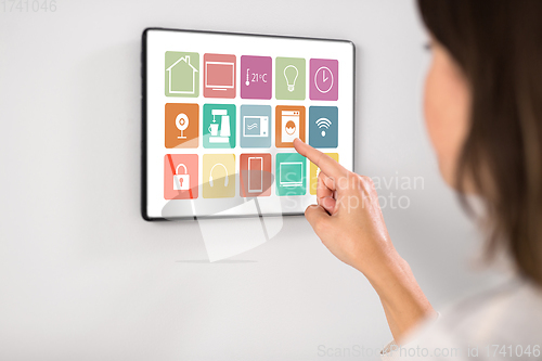 Image of woman using tablet computer at smart home