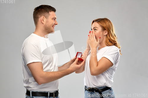 Image of man giving woman engagement ring on valentines day