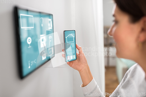 Image of woman using tablet computer and smartphone