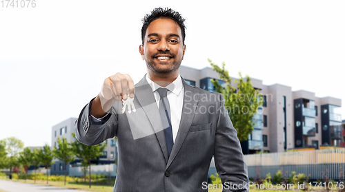 Image of indian man realtor with keys on city street