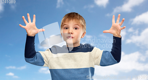 Image of little boy playing over blue sky