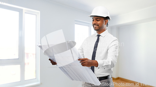 Image of indian male architect in helmet with blueprint