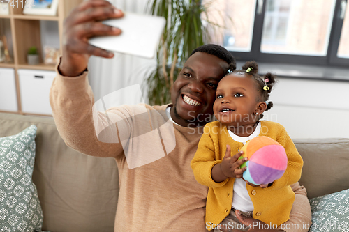 Image of happy father with baby taking selfie at home