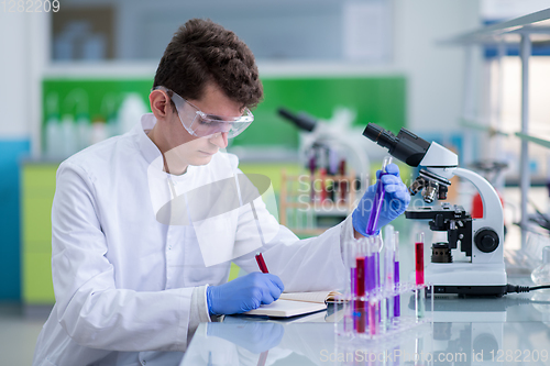 Image of student with protective glasses making chemistry experiment