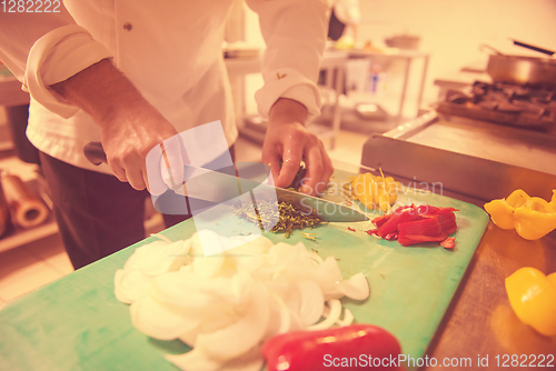 Image of Chef hands cutting fresh and delicious vegetables