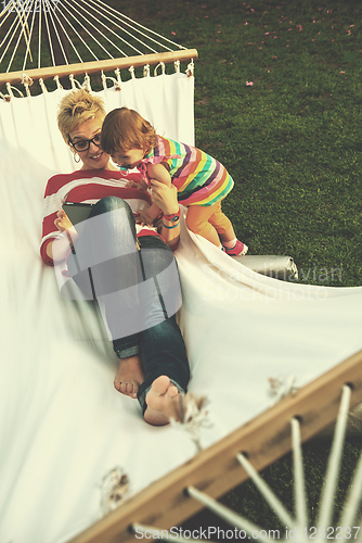 Image of mom and a little daughter relaxing in a hammock