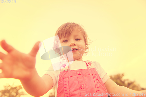 Image of little girl spending time at backyard