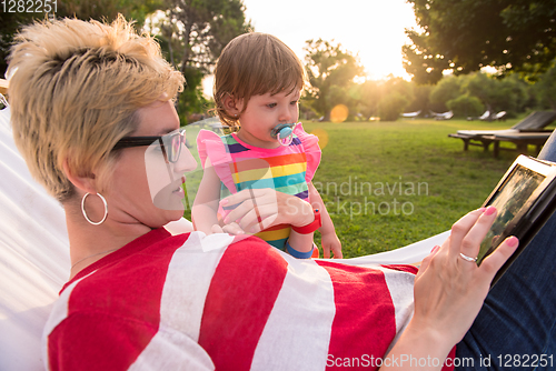 Image of mom and a little daughter relaxing in a hammock